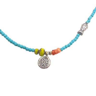 a strung bead necklace of turquoise beads and small silver beads with a toggle clasp.