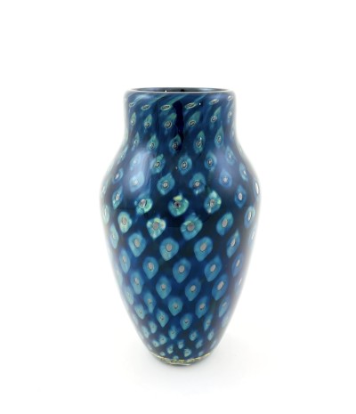 a handblown glass vase with a narrow opening, a shouldered top that narrows to the base with a deep blue and lighter blue cat-eye pattern.