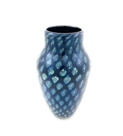 a handblown glass vase with a narrow opening, a shouldered top that narrows to the base with a deep blue and lighter blue cat-eye pattern.