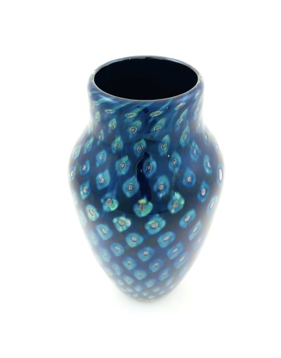 a handblown glass vase with a narrow opening, a shouldered top that narrows to the base with a deep blue and lighter blue cat-eye pattern.