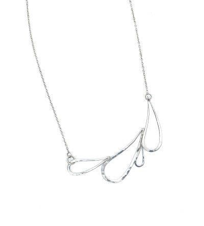 A handcrafted Sterling silver necklace with a series of droplet shapes joined to make a horizontal design with a subtle hammered surface.