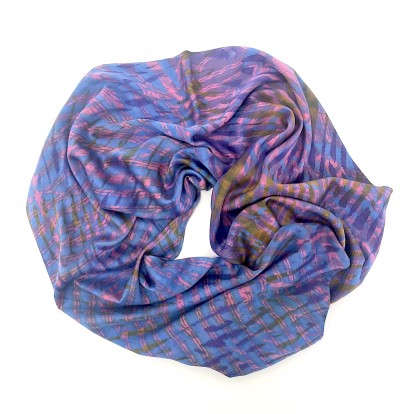 a multi color silk scarf with pink, purple and blue criss cross design arranged in a circle.