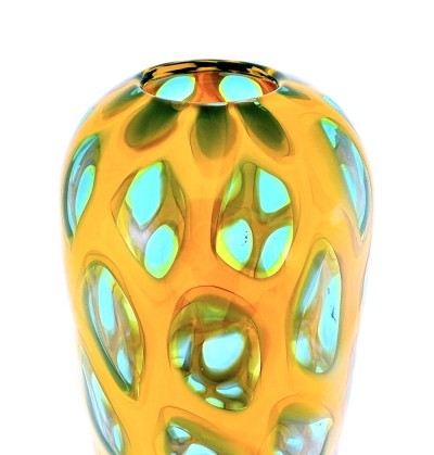 a tall narrow handblown glass conical shaped vase with a gold colored body and clear glass ovals outlined in turquoise.