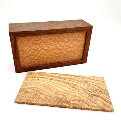 a handmade rectangular walnut box with a light applewood lid.
