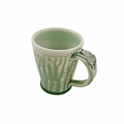 Soft green glazed mug adorned with a small bat