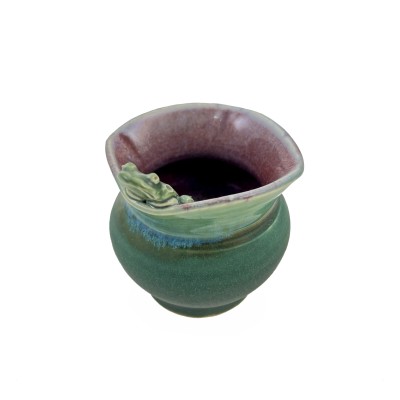 Small bud vase with square rim, burgundy interior, green exterior glaze, and a small frog perched on the rim