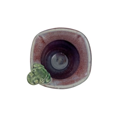 Top view of small bud vase with square rim, burgundy interior, green exterior glaze, and a small frog perched on the rim