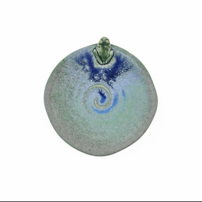 Top view of small green glazed dish with tiny frog and blue glazed accents