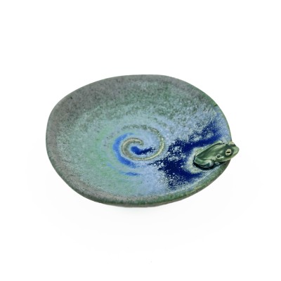 Angled view of small green glazed dish with tiny frog and blue glazed accents