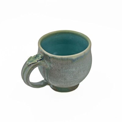 Soft green glazed mug adorned with a small frog