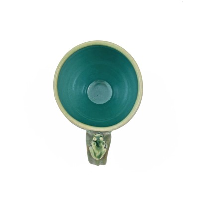 Top view of soft green glazed mug adorned with a small frog