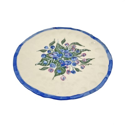 a hand-formed porcelain plate illustrated with bright blueberries and green leaves