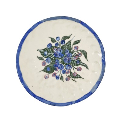 a hand-formed porcelain plate illustrated with bright blueberries and green leaves