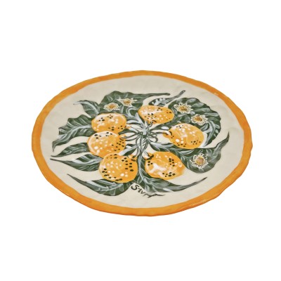 a hand-formed porcelain plate illustrated with bright orange clementines and green leaves