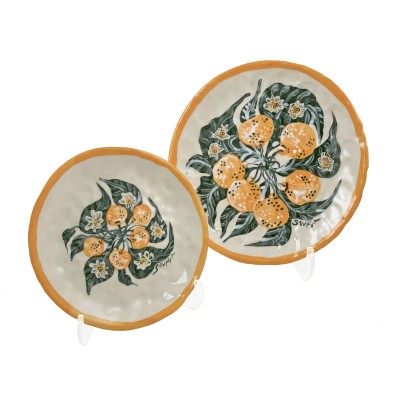 pair of hand-formed porcelain plates illustrated with bright orange clementines and green leaves