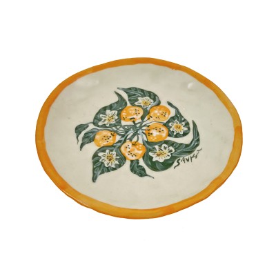 a hand-formed porcelain plate illustrated with bright orange clementines and green leaves