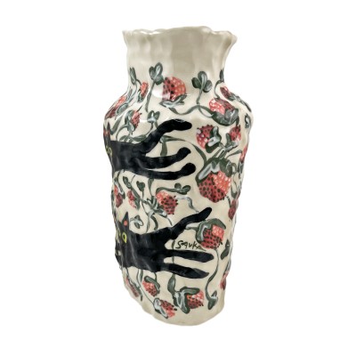 Side view of hand-formed porcelain vase painted with black cats and strawberries