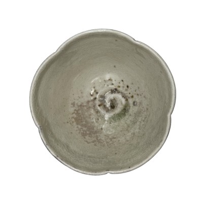 top view of a decorative bowl with a scalloped rim and light colored interior