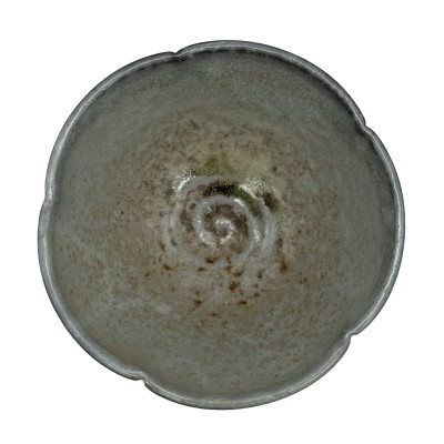 top view of a scalloped-edge bowl with a light swirled interior