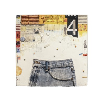 an abstract textural encaustic painting with complex patterns and symbols etched in a white surface background and a partial pair of blue jeans applied to the bottom half.