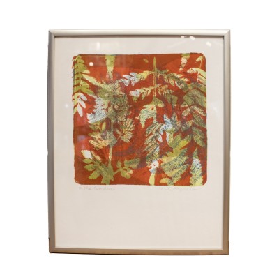 an acrylic mono print of layers of plant shapes, using orange, blue, and yellow-green