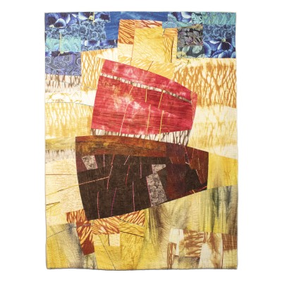 a quilt with shades of red, yellow, and blue