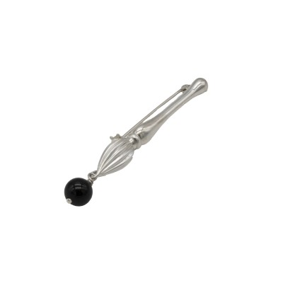 brooch that balances sculptural silverwork with a striking dark accent