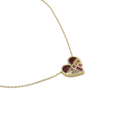 a gold necklace in the shape of a heart adorned with gemstones, including ruby