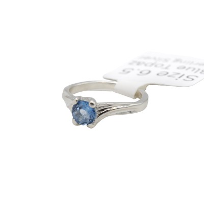 a sterling silver ring made with blue topaz and formal references to tree branches