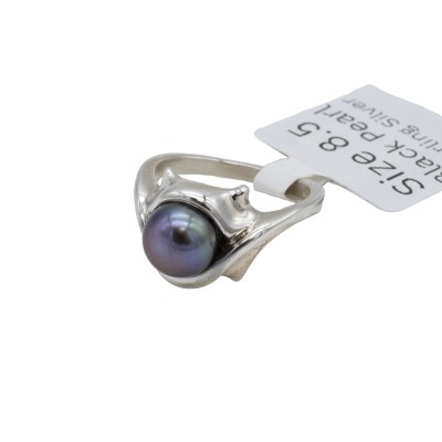 a sterling silver ring with a black pearl and formal references to cats