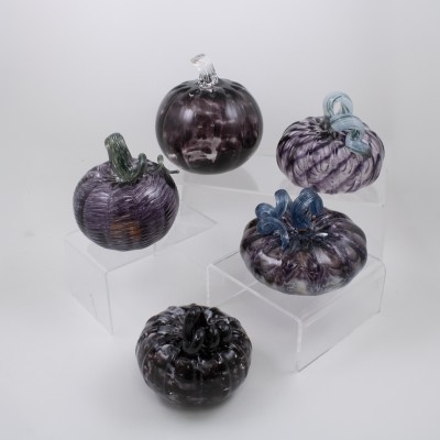a variety of deep purple glass pumpkins