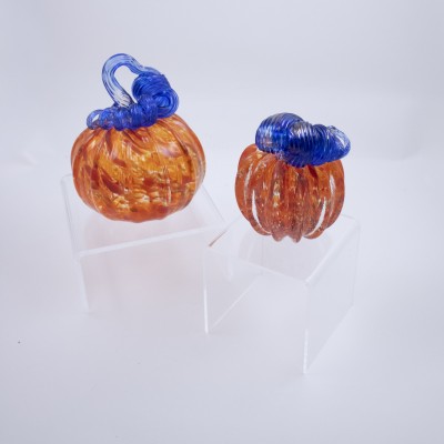 a duo of orange pumpkins with blue stems