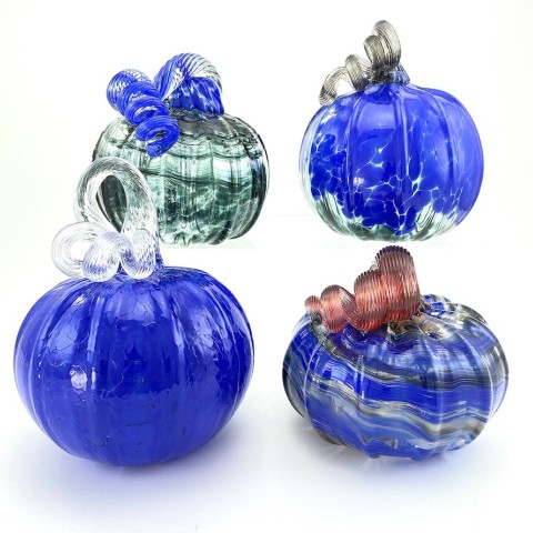 four round blue glasss pumpkins with curly stems.