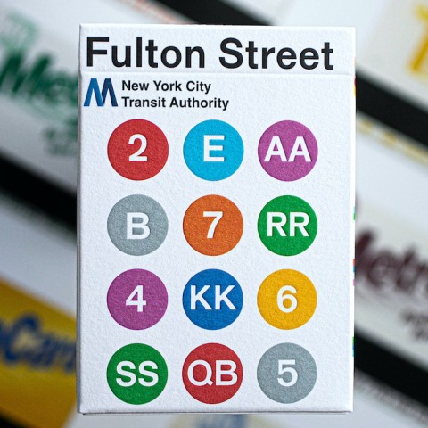 the front of a pack of playing cards with 'Fulton Street' and twelve circles of color on the cover of the box.