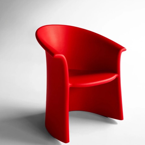 thre quater view of a bright red solid shaped rocking chair. 