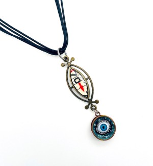 Necklace with a black rope and a pendant containing a metal oblong setting with a cut out piece of ruler embedded into it and a circular blue pendent with an eye dangling from it.