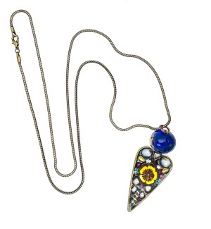 Necklace with a chain and a long heart pendant containing floral elements below a blue bead.