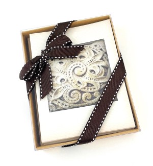 Boxed notecard set with image of architectural stonework and a bow around the box.