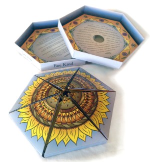 A hexagonal folding book with an illustration of a sunflower.