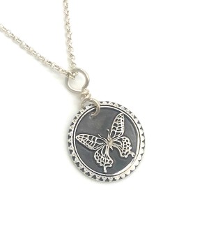 Sterling Silver round Pendant with a butterfly on it and a decorative edge.