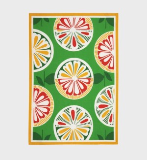 Tea towel with a green background and yellow border, there are graphic representations of citrus fruit arranged in columns in shades of red, green, and yellow.