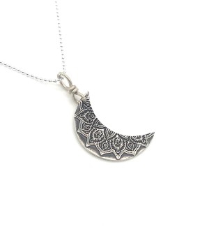Sterling Silver crescent moon pendant with mandala pattern on it on a ball chain.