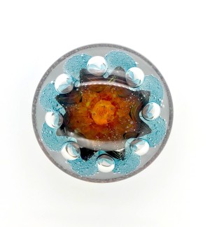 Handblown clear Glass orb with bubbly amber and blue organic shape inside.