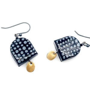 A pair of earrings shaped like black arches with blue dots, a yellow oval disk hangs below.
