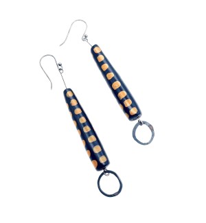 A pair of earrings with a black cylinder shape covered in neat rows of mustard yellow dots, a small open loop hangs from the bottom.