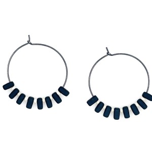 A pair of hoop earrings with alternating black and white beads.