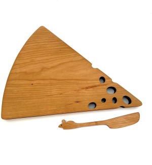 A wooden cutting board shaped like a wedge of cheese with small holes at one end pictured next to a cheese spreading knife in the shape of a mouse.