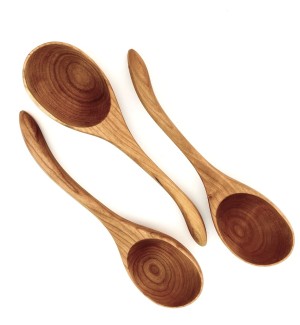 Three wooden ladles with slightly curved handles.