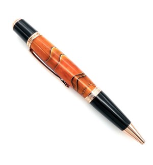 A pen with gold hardware, the center of the body is orange with black swirls and the grip is solid black.