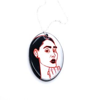 hand painted Ceramic Necklace with a red line drawing of a woman with her chin resting on her hand as well as black hair, lips, pupils, and eyebrows.